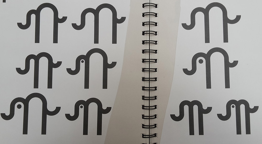 printed out alternative versions of the logo in development