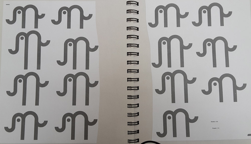 printed out alternative versions of the logo in development