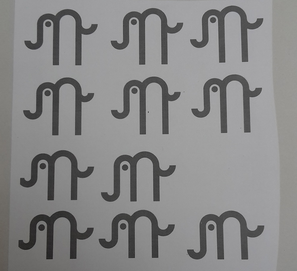 printed out alternative versions of the logo in development